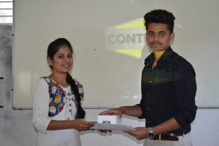 Supervisor Megha awarding intern Narasimha